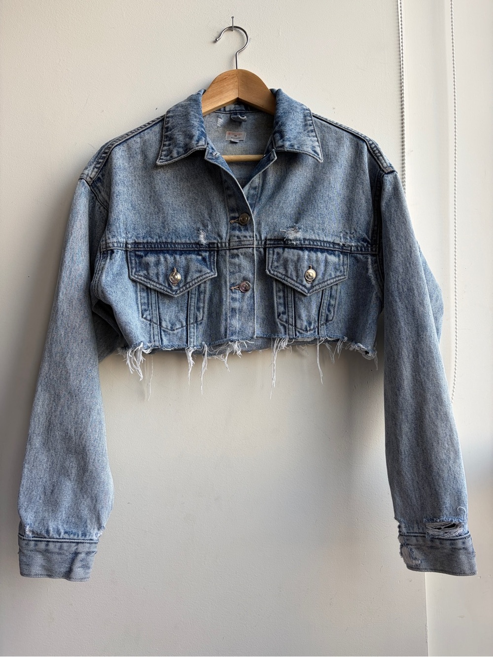 Madison Light Blue Cropped Denim Jacket with distressed hemline